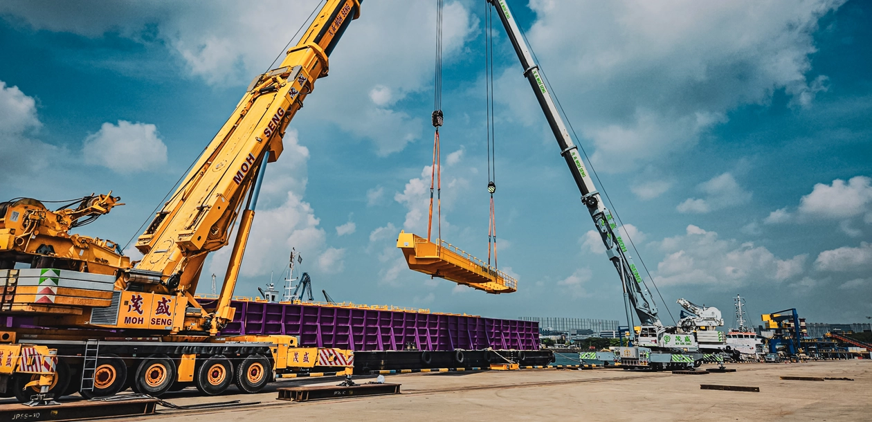 Mobile cranes loading cargo onto vessel